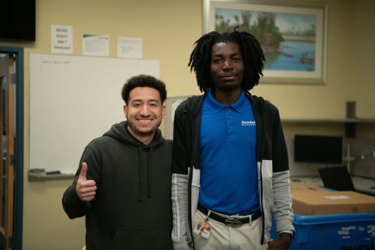 Goodwill Manasota Desktop Support Technician Altone Wasike (right), who has benefited from Goodwill’s Free Education program, with co-worker Jorge Abdul Hernandez 