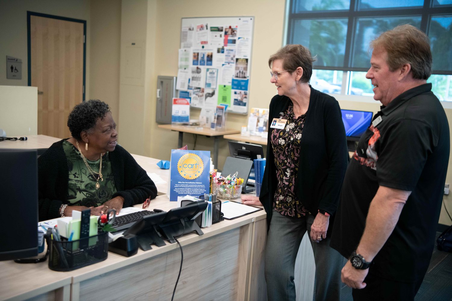 Goodwill team members Dorothy Mills, Margie Genter, and Randy Wright celebrating CARF accreditation.