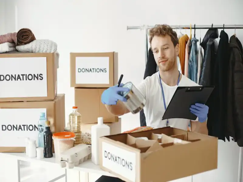 Volunteer collecting Goodwill household items donation Volunteer collecting Goodwill household goods donation