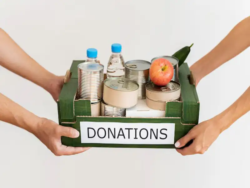 Volunteer collecting Goodwill household items Volunteer collecting household goods donations stuff