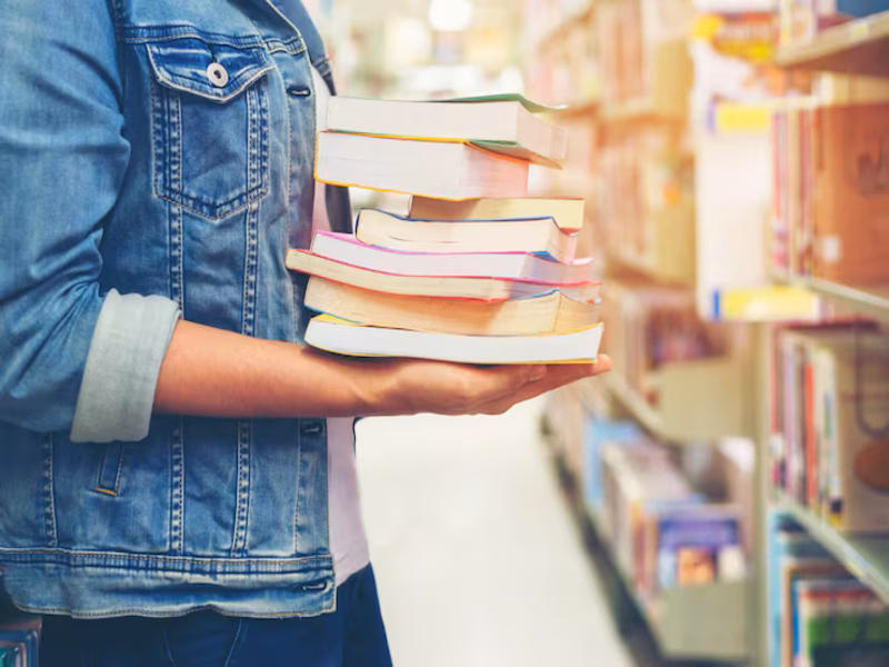Reader searching for affordable titles at a local used book store in bradenton