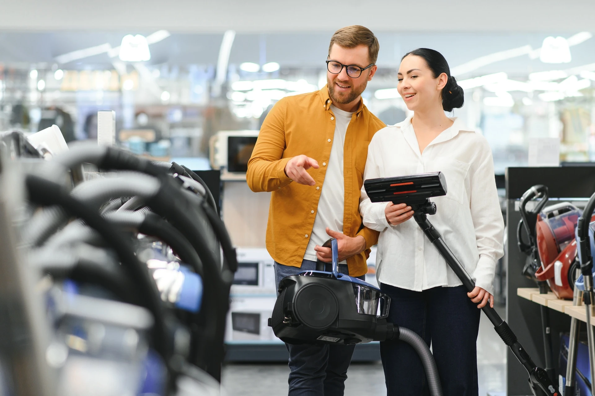 couple choosing vacuum cleaner in west palm beach goodwill appliances store