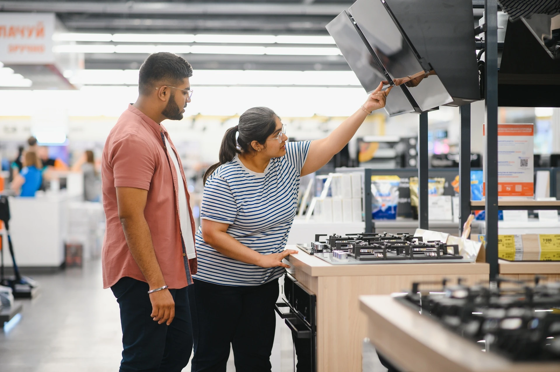 selecting gas stove in Manasota Goodwill store in Bradenton