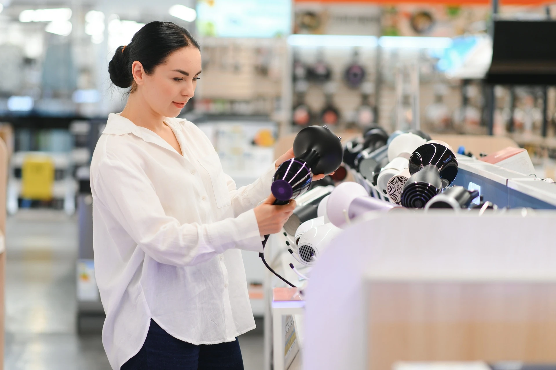 woman selecting hair dryer at goodwill manasota appliances store