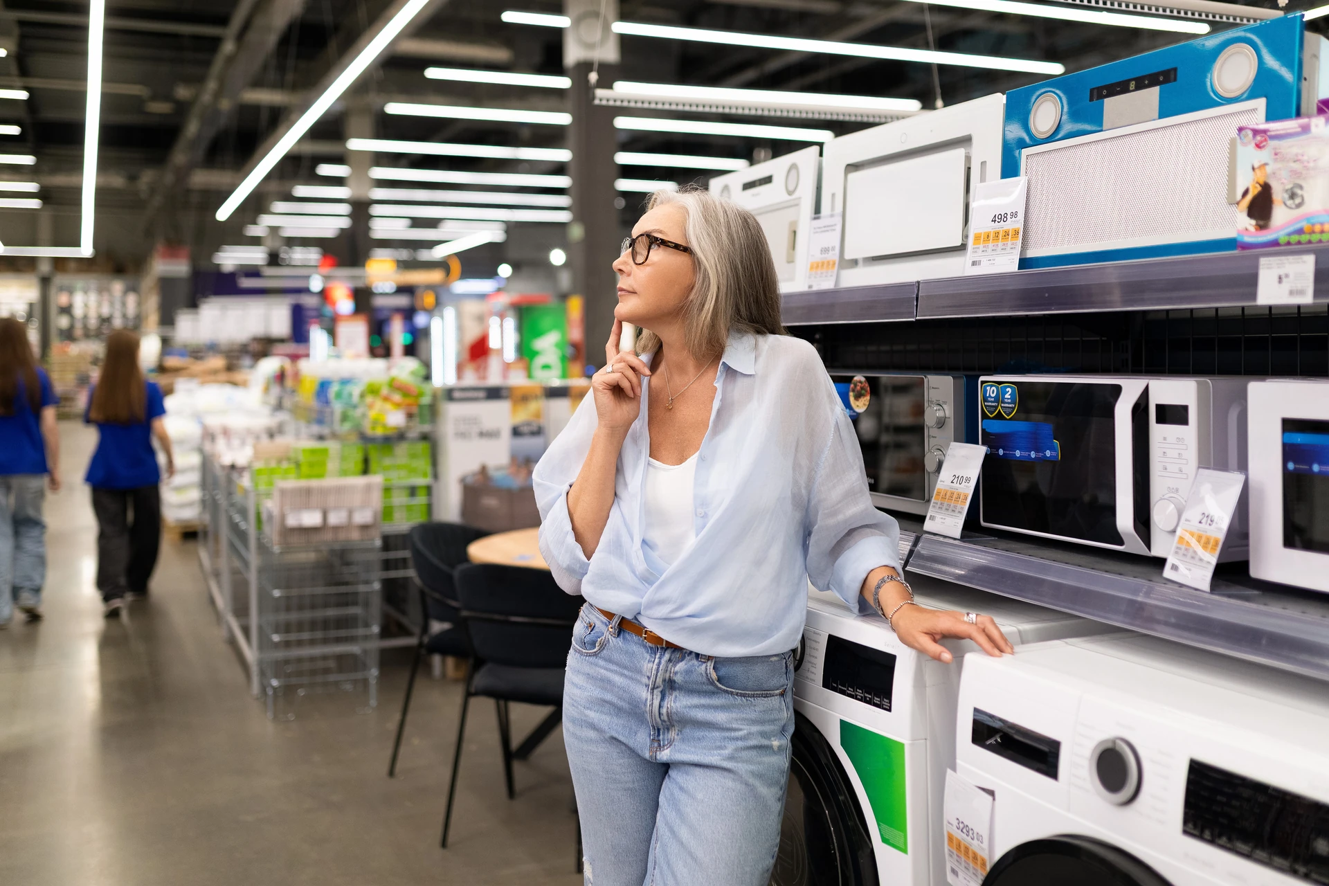 woman selecting kitchen appliances in manasota goodwill