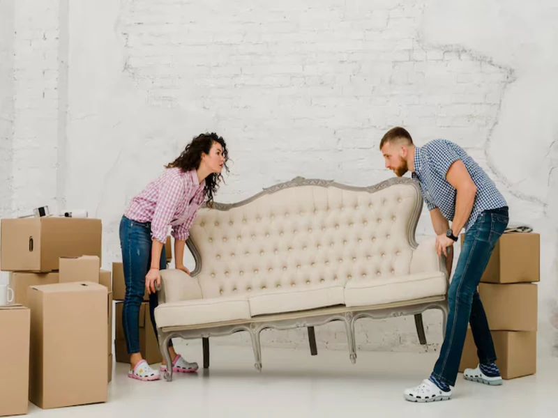 arrangement of used sofas and chairs by young couple in living room