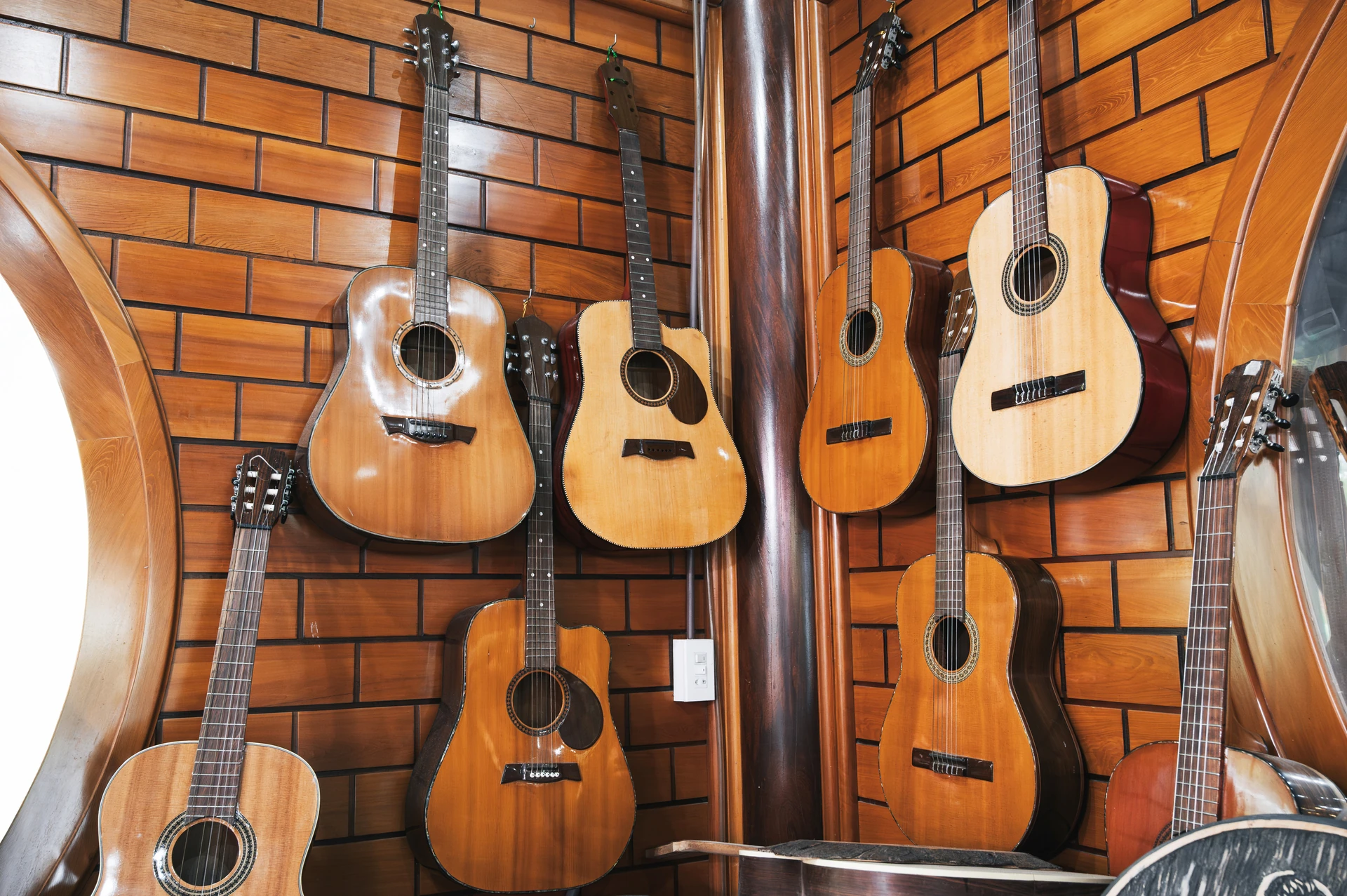 classical used guitars in boca raton hanging on wall racks
