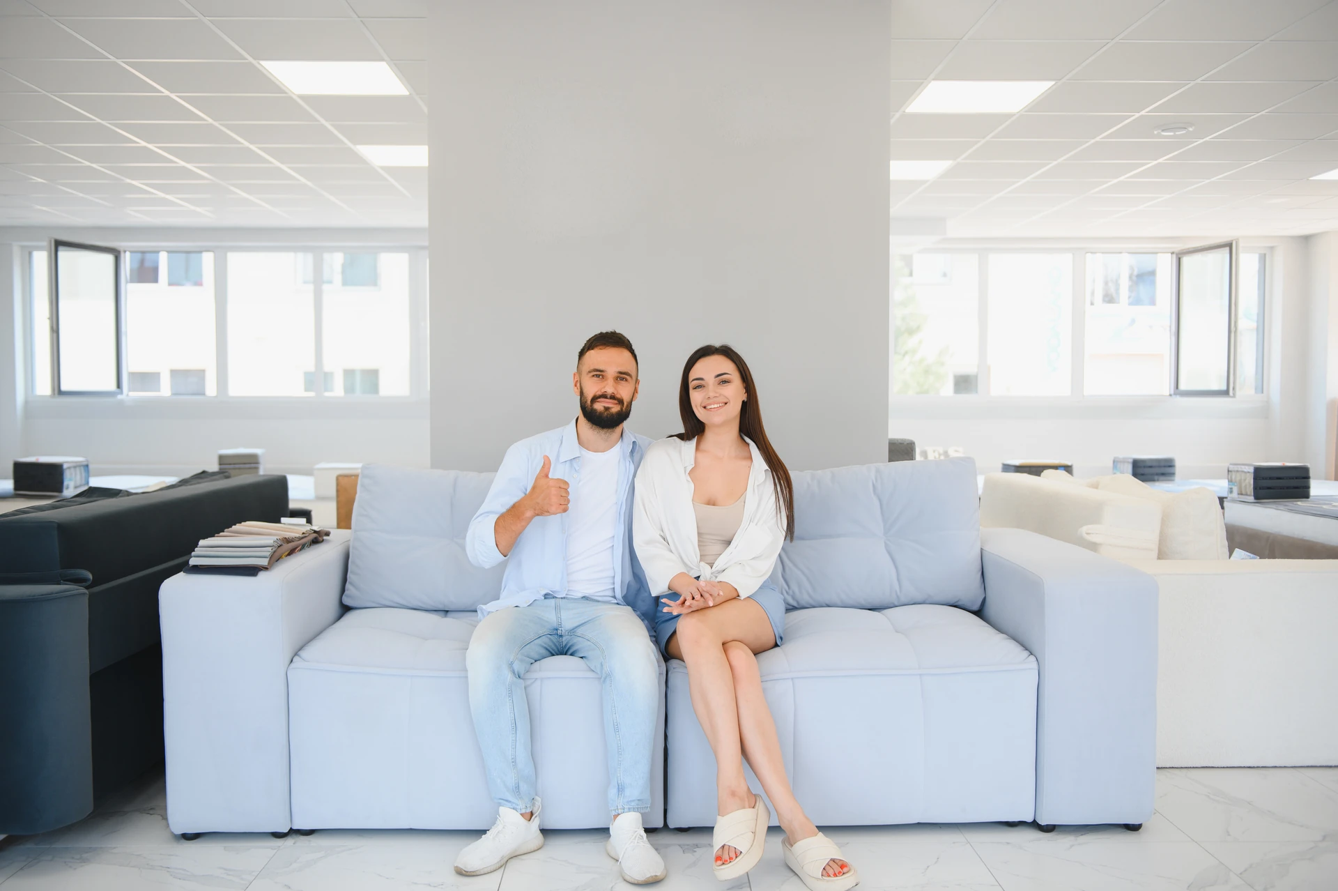 couple choosing furniture from a broad selection at a second hand furniture store