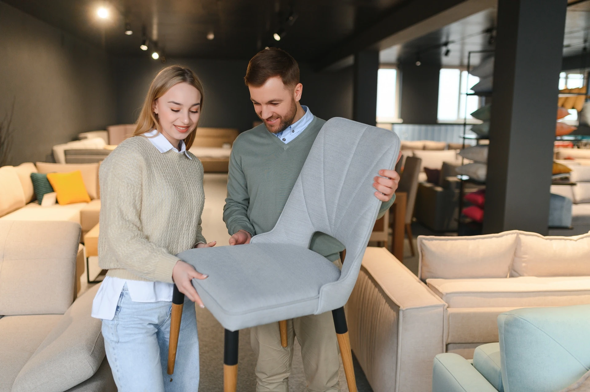 couple comparing chairs while shopping at goodwill furniture in sarasota