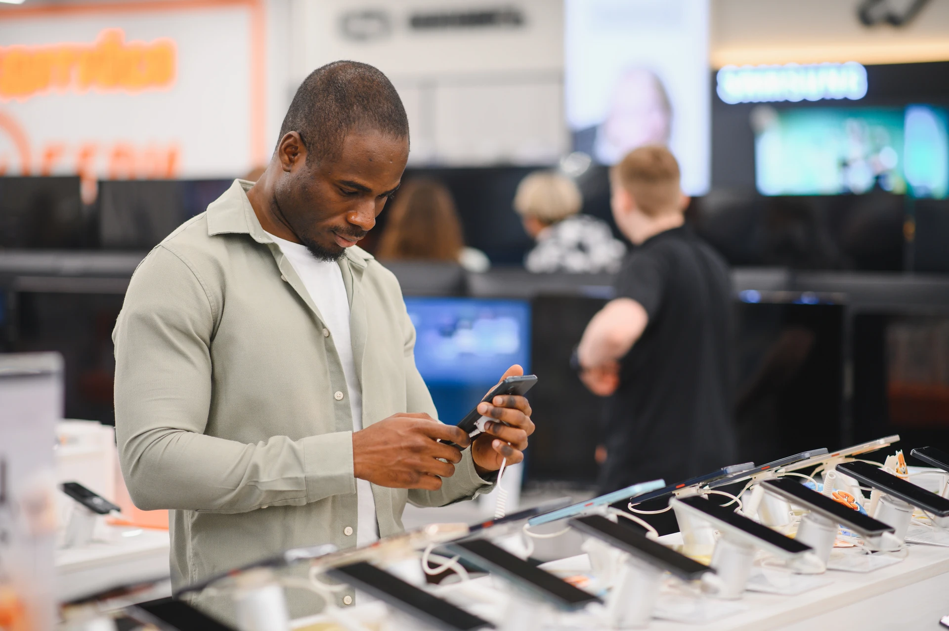 customer comparing smartphones in electronics store