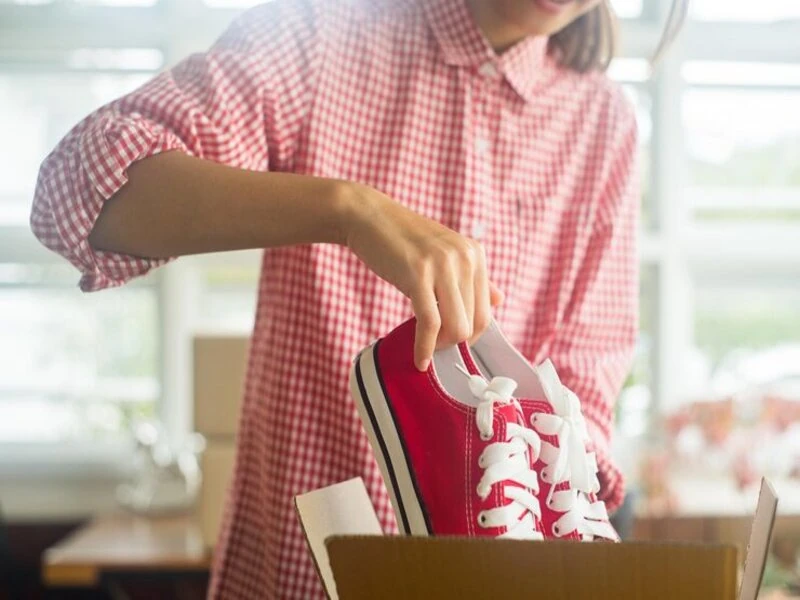 customers looking selected pair of shoes in a bright store