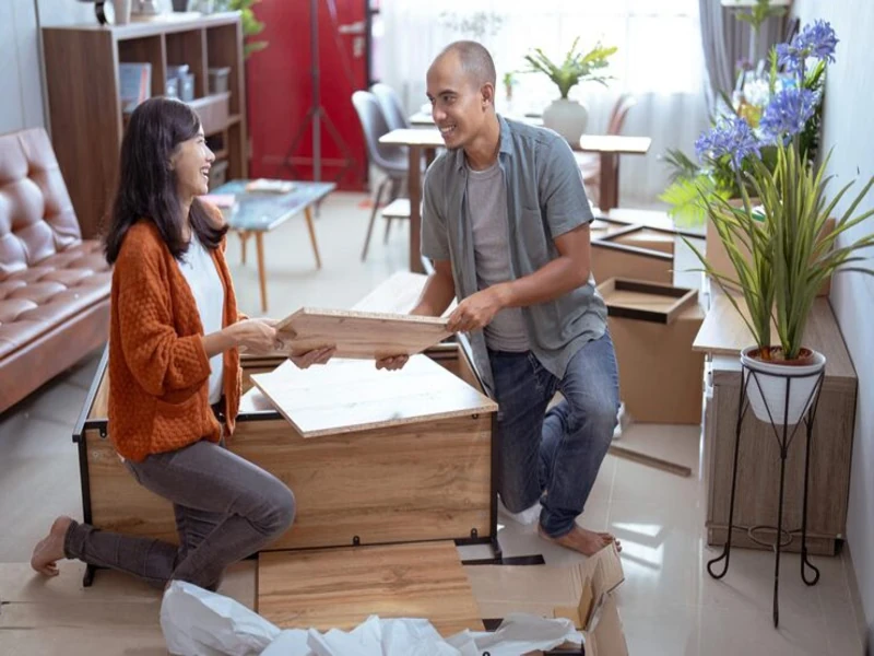family placing wooden furniture purchased from used furniture store