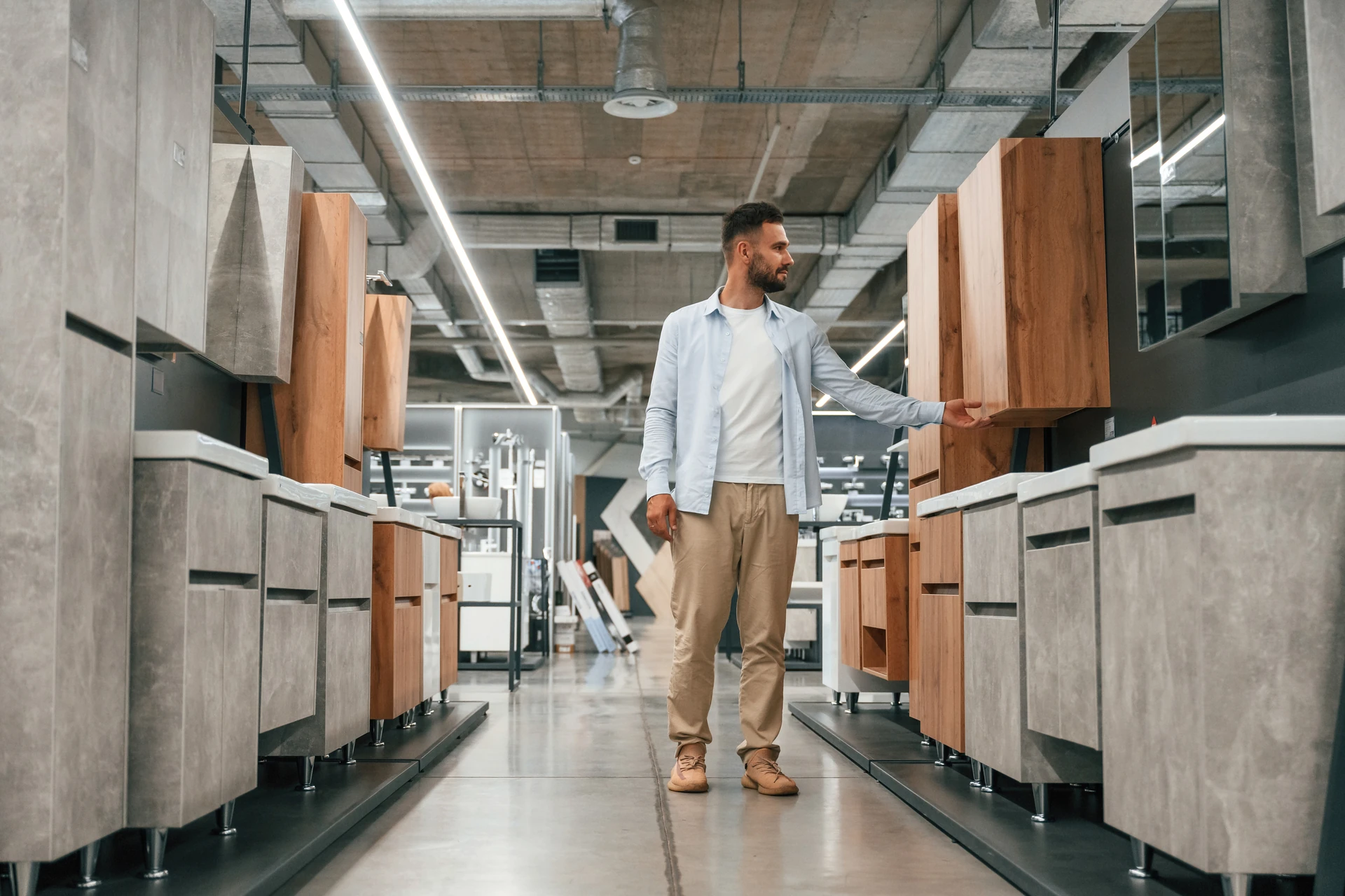 man browsing storage cabinets at goodwill furniture store in bradenton
