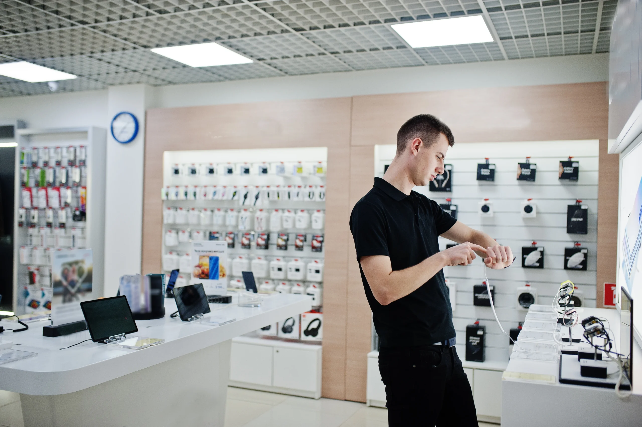 man choosing smartwatch display at goodwill computer store electronics section in bradenton