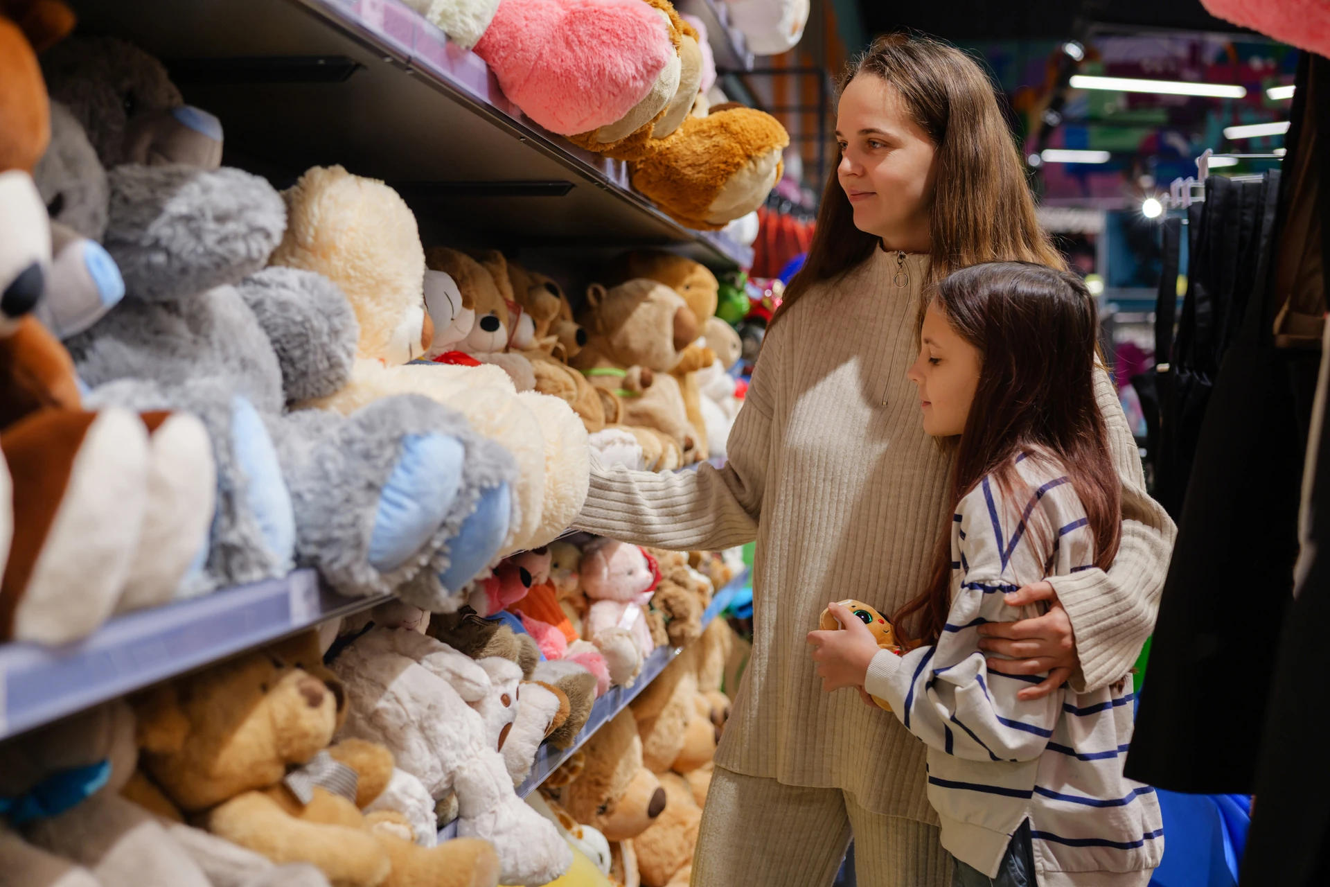 parents and children browsing used toys at a goodwill toy store in boynton beach