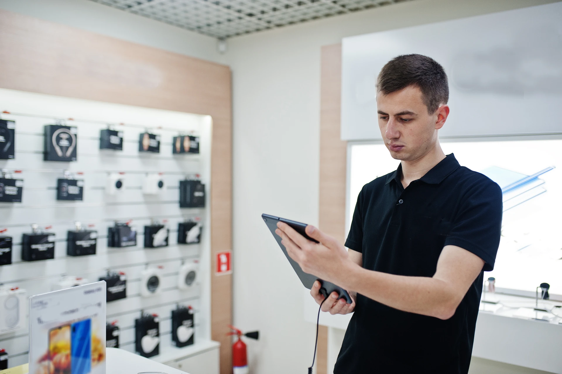 professional consultant checking mobile phone at electronics store