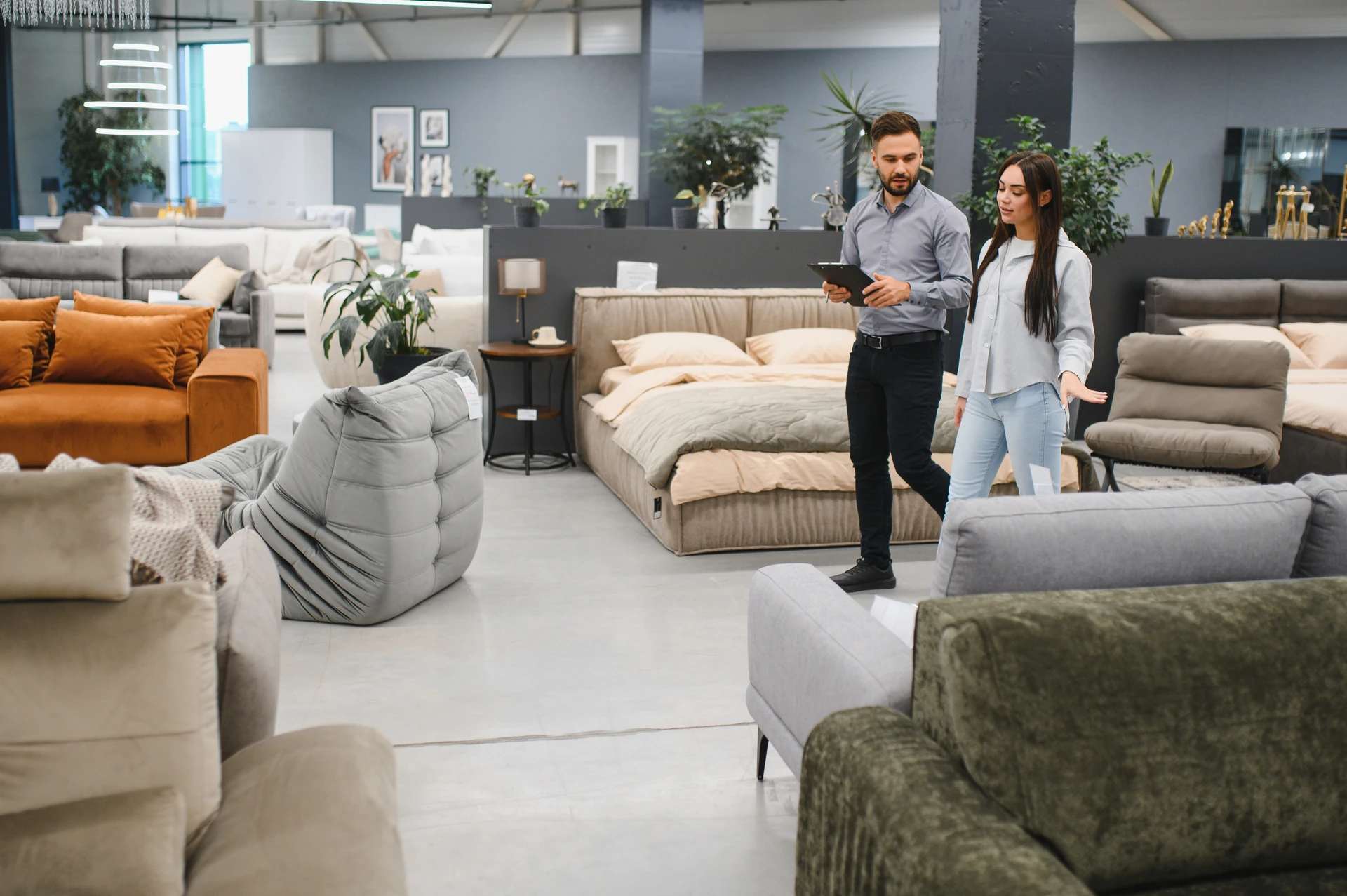 professional consultant showing used furniture to customer at goodwill furniture store