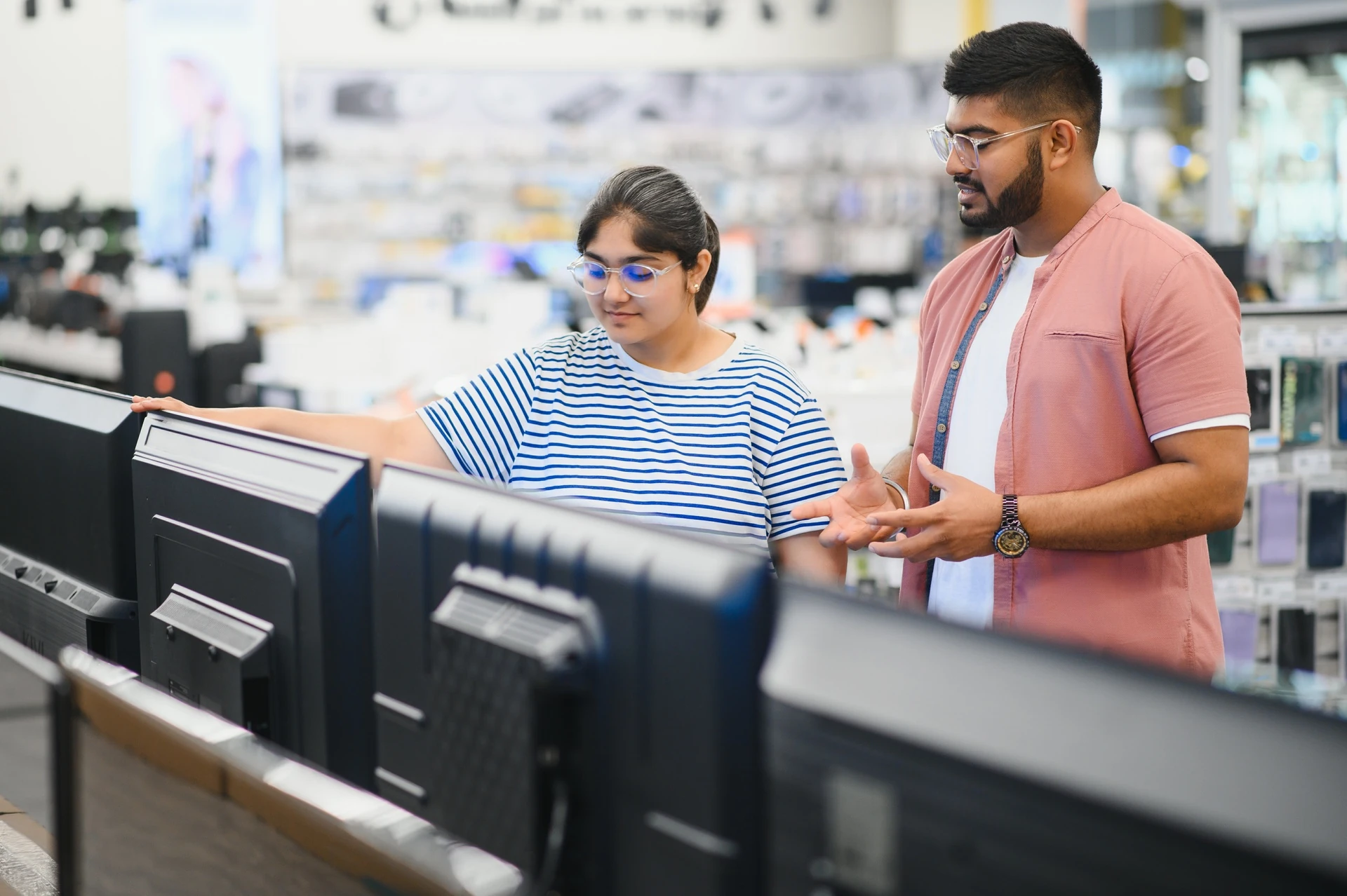shopper browsing a monitors among used electronics in boca raton