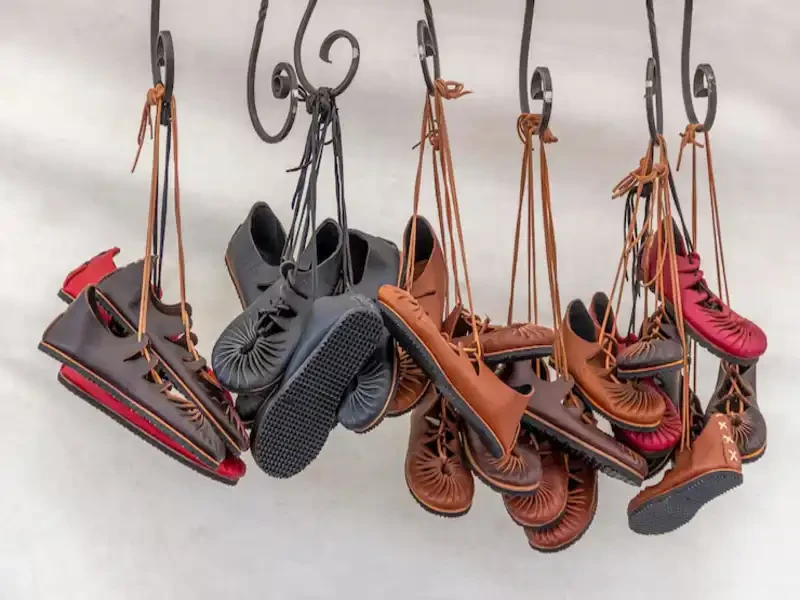 stylish thrift store shoes hanging on the hooks for display