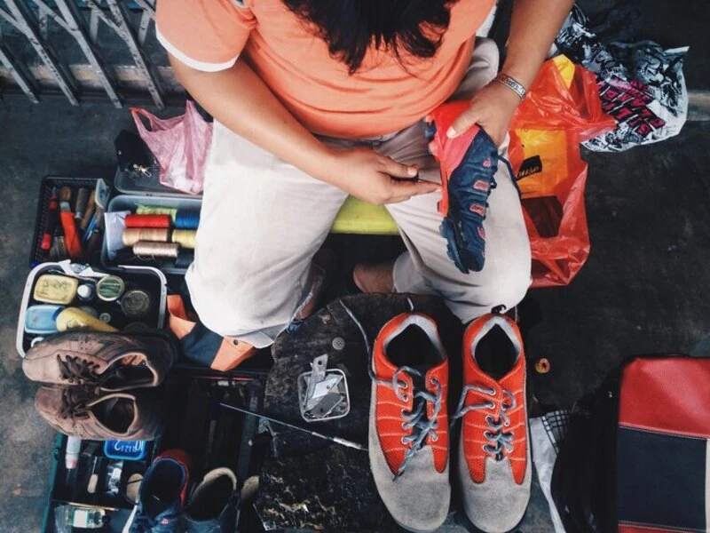 volunteers arranging sneakers to reuse to display side by side for shoppers